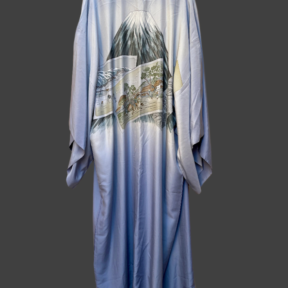 Blue kimono with mountain and landscape design on a beige background