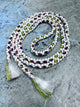 A braided white cord belt from Japan with alternating olive green and dark reddish-brown braided silk, finished with two white tassels