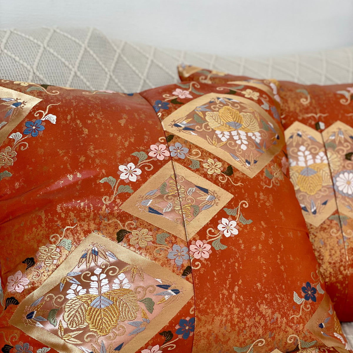 Cushion cover upcycled from obi sash with embroideries in deep orange