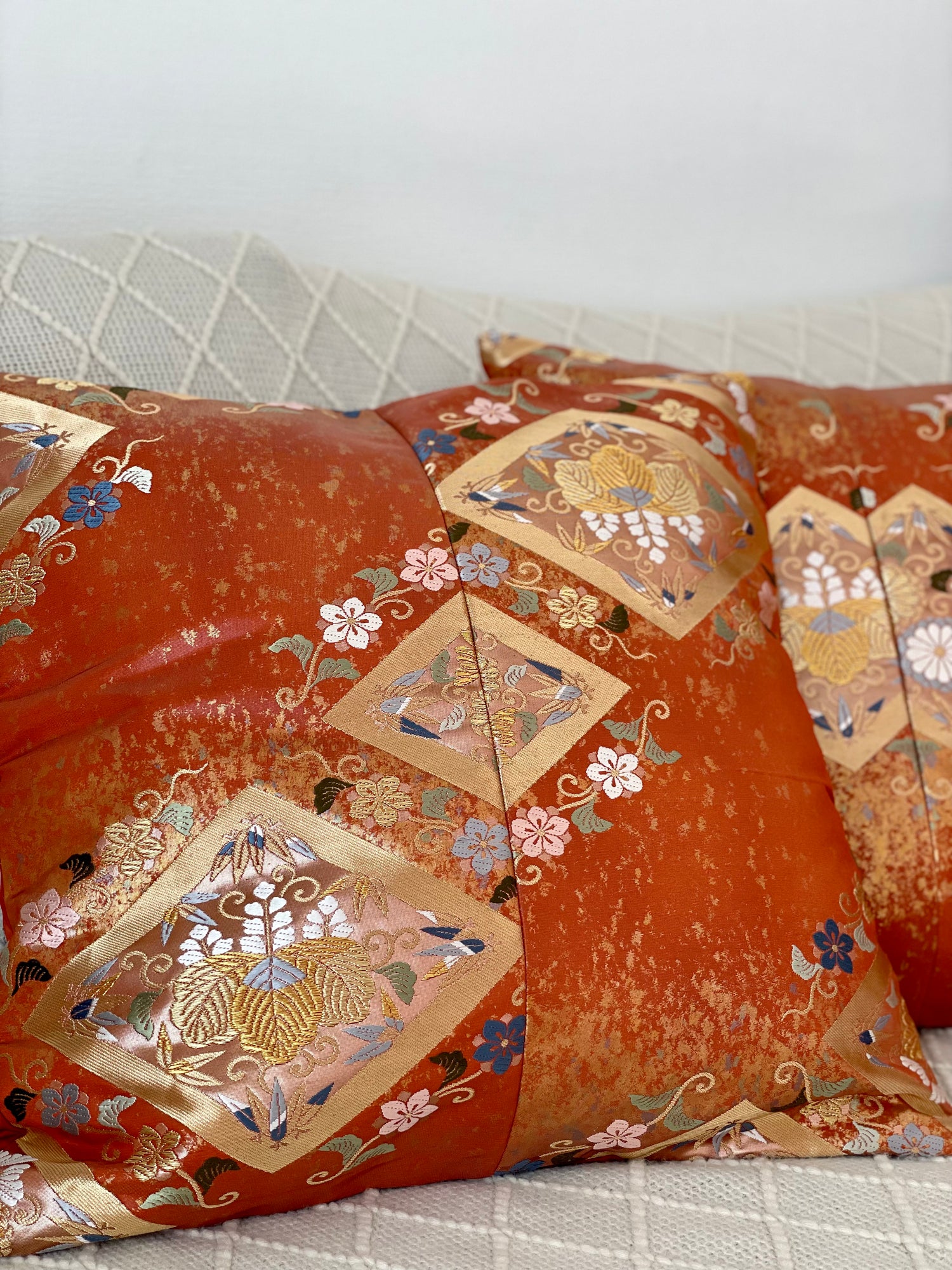 Cushion cover upcycled from obi sash with embroideries in deep orange