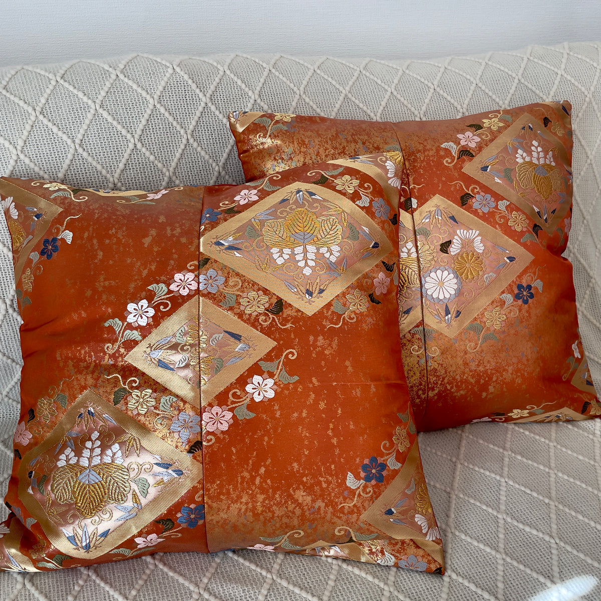 Cushion cover upcycled from obi sash with embroideries in deep orange