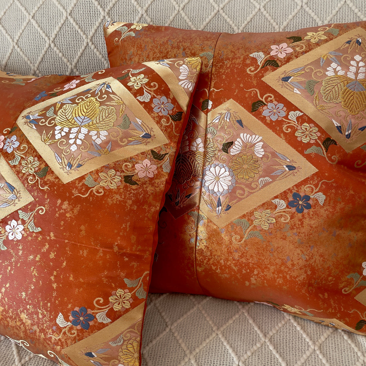 Cushion cover upcycled from obi sash with embroideries in deep orange