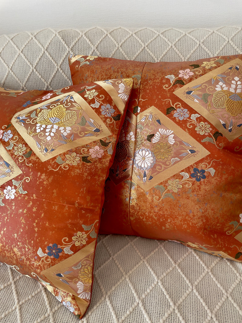 Cushion cover upcycled from obi sash with embroideries in deep orange