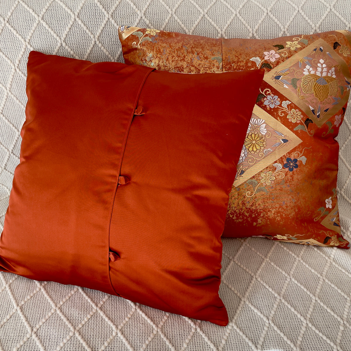 Cushion cover upcycled from obi sash with embroideries in deep orange