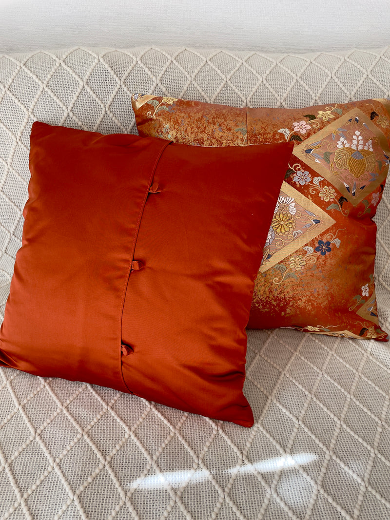 Cushion cover upcycled from obi sash with embroideries in deep orange