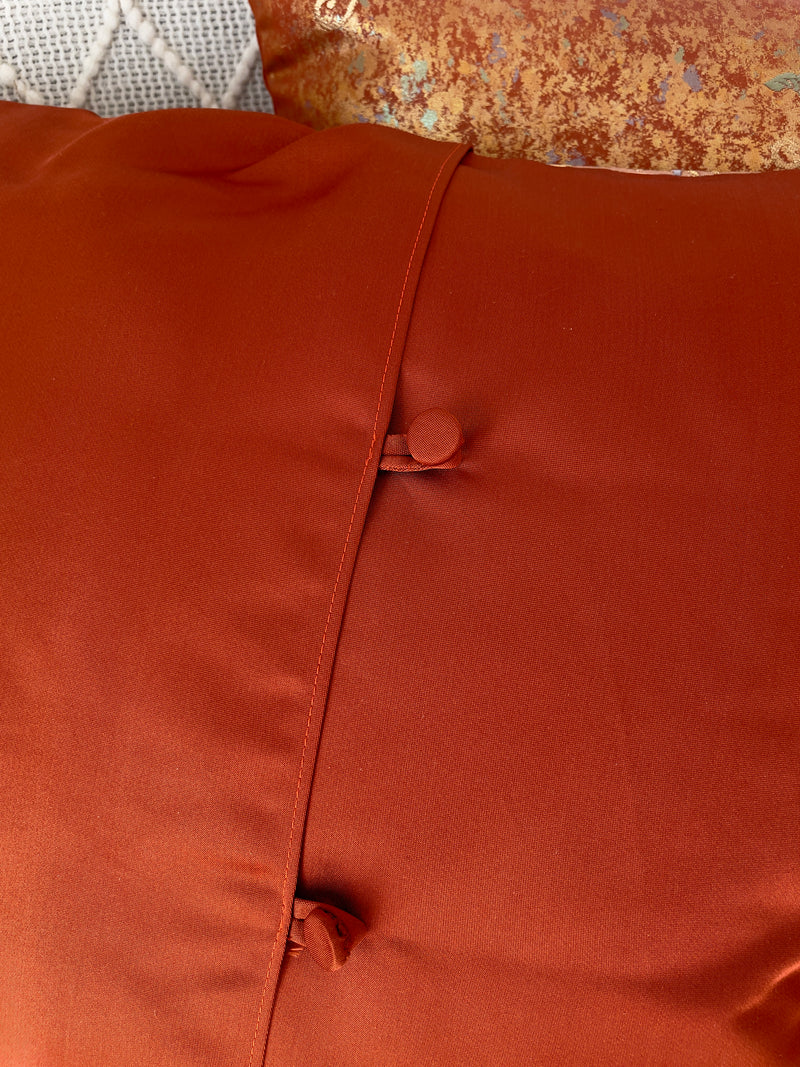 Cushion cover upcycled from obi sash with embroideries in deep orange